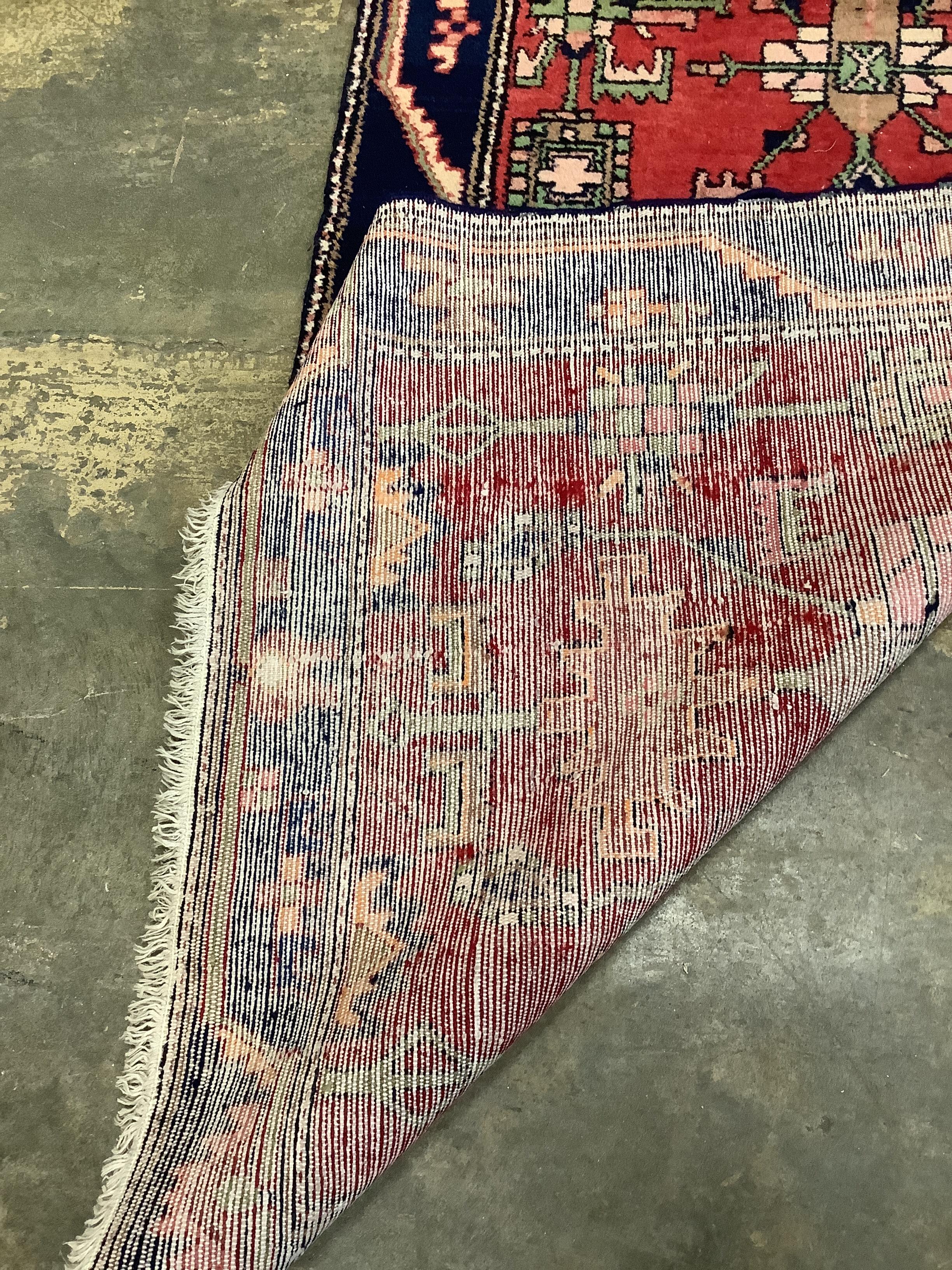 A Nahavand North West Persian red ground runner, 492cm x 110cm